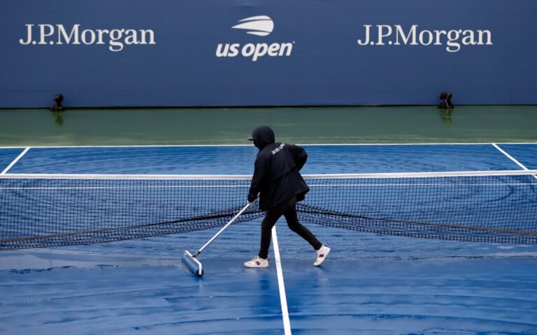 Osaka advances by walkover and Halep wins at rain-hit US Open